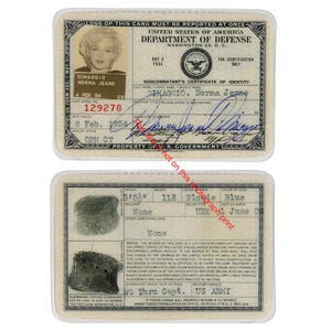 May include: A vintage noncombatant's certificate of identity. The card features a photo of Norma Jeane, with details including her name, date of birth, and physical characteristics. The card is encased in a protective sleeve.