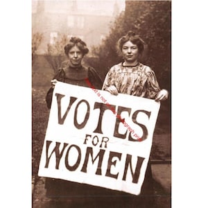 May include: Sepia-toned photograph of two women holding a sign that reads "VOTES FOR WOMEN." The women are dressed in period clothing, and the sign is handwritten in bold, dark letters. The image evokes a sense of historical activism.