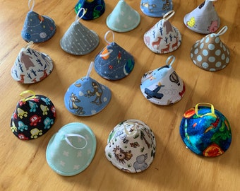 May include: A collection of 15 colorful fabric cone-shaped teethers with various patterns and designs. The teethers are made of soft fabric and have a loop for easy hanging.