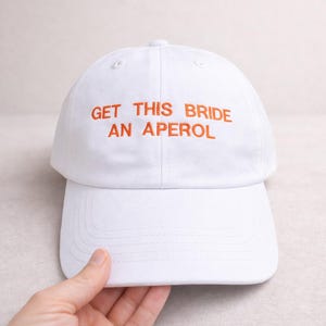White embroidered bride cap for hen party with custom drink text, bachelorette weekend accessory and bridal shower gift