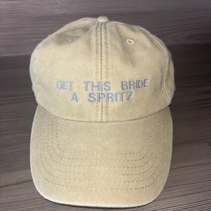Custom bride hat for hen do with orange embroidered slogan, personalised bachelorette gift idea for bride