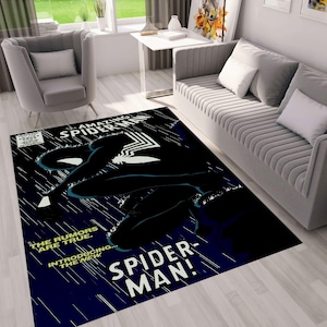 May include: A blue and black rug with a comic book cover design featuring Spider-Man. The text on the cover reads "Amazing Spider-Man" and "The rumours are true... Introducing the new Spider-Man!"