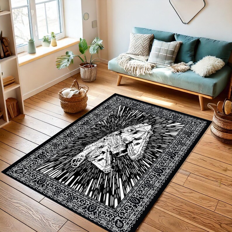 May include: Black and white area rug featuring a detailed illustration of a spaceship with a burst effect. The rug has a decorative border and is placed on a hardwood floor. The rug is rectangular in shape.