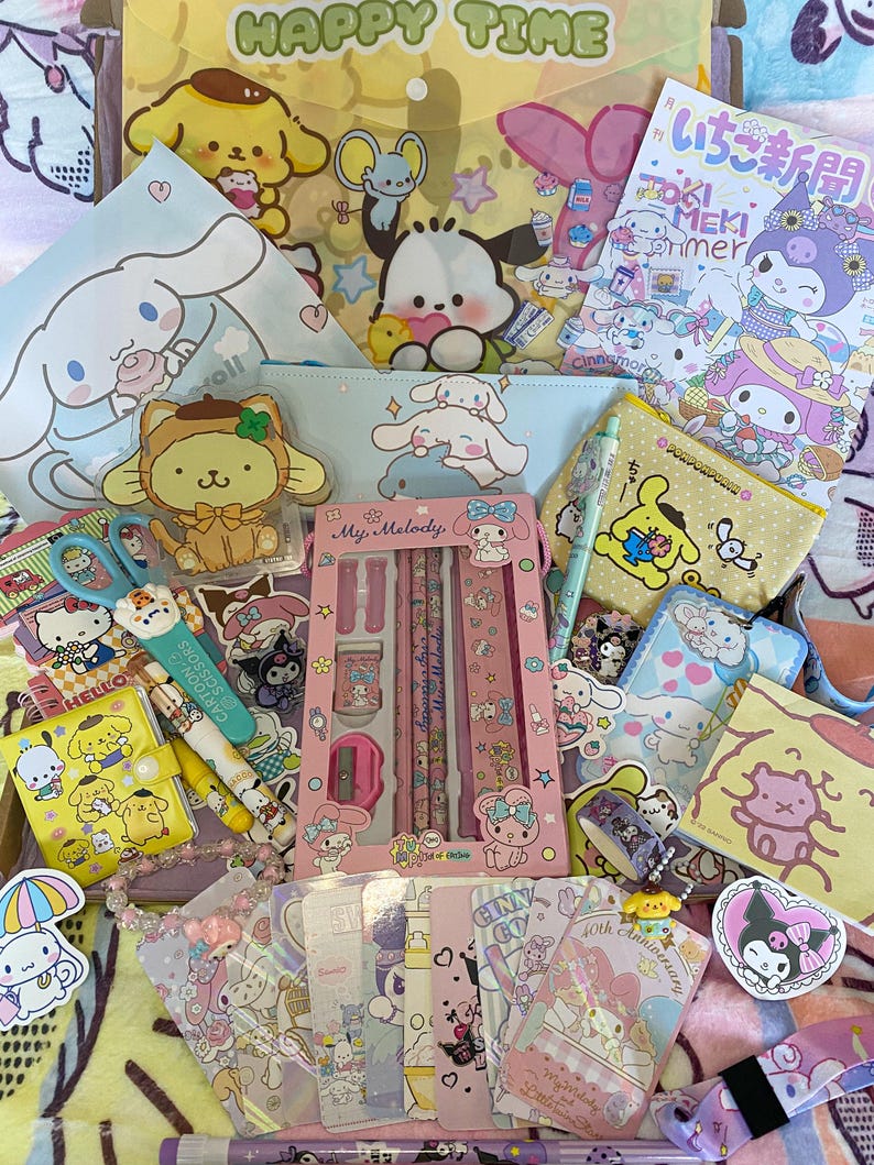 May include: A collection of My Melody and Cinnamoroll stationery and accessories, including a pencil case, a ruler, a notepad, stickers, and a charm. The items are all pink and white with images of the characters. The text on the items includes "My Melody" and "Cinnamoroll".