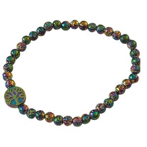 May include: A rainbow iridescent beaded bracelet with a tree of life charm. The beads are small and round, and the charm is silver with a green tree design.