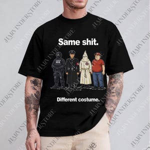 May include: Black t-shirt with the text "Same shit." above an illustration of four figures in different uniforms and costumes. Below the illustration is the text "Different costume."