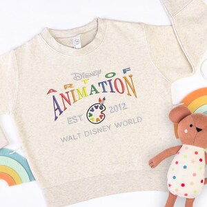 Moletom infantil bordado WDW Art of Animation Resort: Fundado em 2012