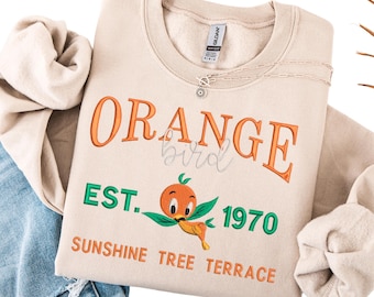Bluza Disney z haftowanym pomarańczowym ptakiem: Sunshine Tree Terrace, założona w 1970 r.