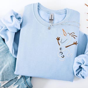 May include: A white ceramic mug with a black handle and the text "But First, Coffee" in a bold, black font. The mug is set against a neutral background, highlighting its simple design.