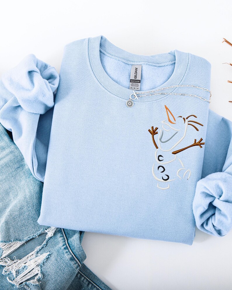 May include: A white ceramic mug with a black handle and the text "But First, Coffee" in a bold, black font. The mug is set against a neutral background, highlighting its simple design.