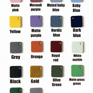 May include: An assortment of small, square items in a range of colours, each with a small hole and the letter "S". Colours include matte pink, Morandi purple, muted baby blue, baby blue, yellow, matte purple, Nordic blue, dark blue, grey, orange, royal red, white marble, black, gold, olive green, matte grass green, dark green, and silver.