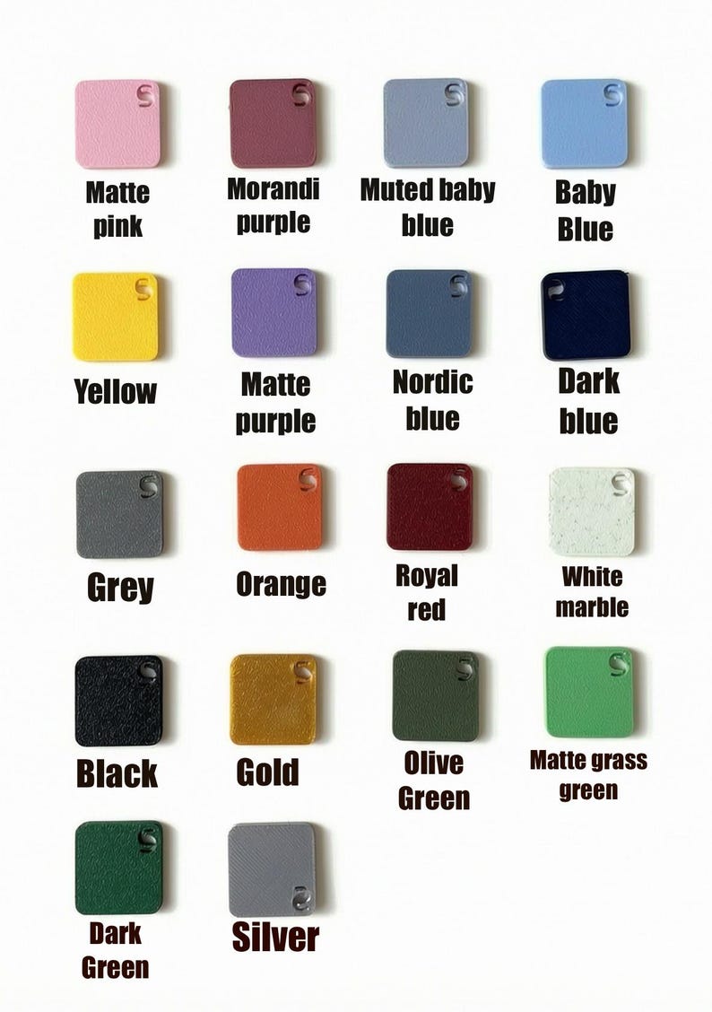 May include: An assortment of small, square items in a range of colours, each with a small hole and the letter "S". Colours include matte pink, Morandi purple, muted baby blue, baby blue, yellow, matte purple, Nordic blue, dark blue, grey, orange, royal red, white marble, black, gold, olive green, matte grass green, dark green, and silver.