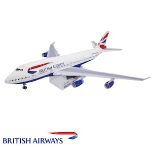 May include: A white, blue, and red paper model of a British Airways Boeing 747-400 airplane. The model has the British Airways logo and "British Airways" written on the side. The model is on a white background.