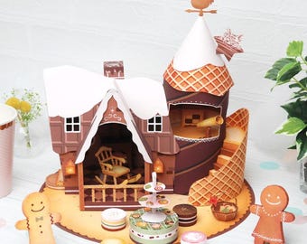 Op de afbeelding: Een peperkoekhuis met een wit dak en bruine muren. Het huis heeft een veranda met een schommelstoel en een peperkoekman die ervoor staat. Er zijn ook peperkoekkoekjes en een peperkoektoren met een wafelkegelontwerp.