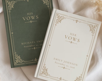 May include: Two hardcover vow books with gold foil detailing. The dark green book is titled HIS VOWS with the name MICHAEL SMITH and date November 21, 2026. The white book is titled HER VOWS with the name EMILY JOHNSON and date November 21, 2026.
