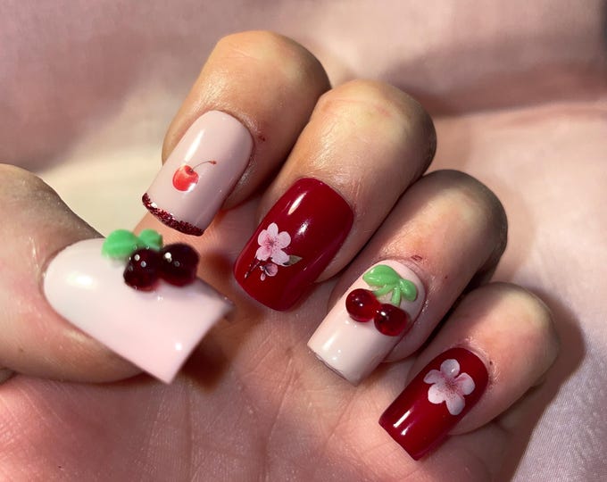 24 pieces. Short square. Small embossed cherries. Sizes 0 to 9. False nails, press-on nails. Reusable. Glossy finish