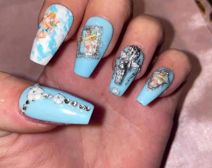 22-piece kit. Little angels, blue, silver, and rhinestones. Sizes 0 to 10. Reusable, press-on nails, false nails. Glossy finish