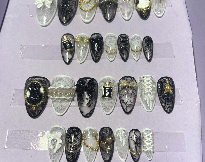 28-piece kit. Black and white lace with embellishments. Sizes 0 to 11. Reusable, press-on nails, false nails. Glossy finish