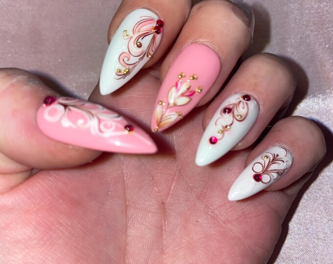 28-piece kit. Pink and white patterned with raspberry rhinestones. Sizes 00 to 9. Reusable, Press-on nails, false nails, Matte finish