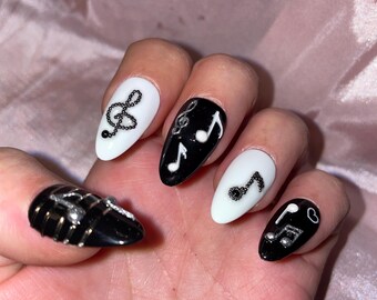 Some musical notes, black, white and silver. Reusable, Press-on nails, false nails. Glossy finish