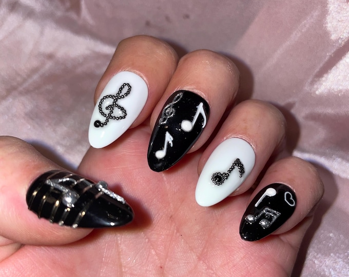Some musical notes, black, white and silver. Reusable, Press-on nails, false nails. Glossy finish