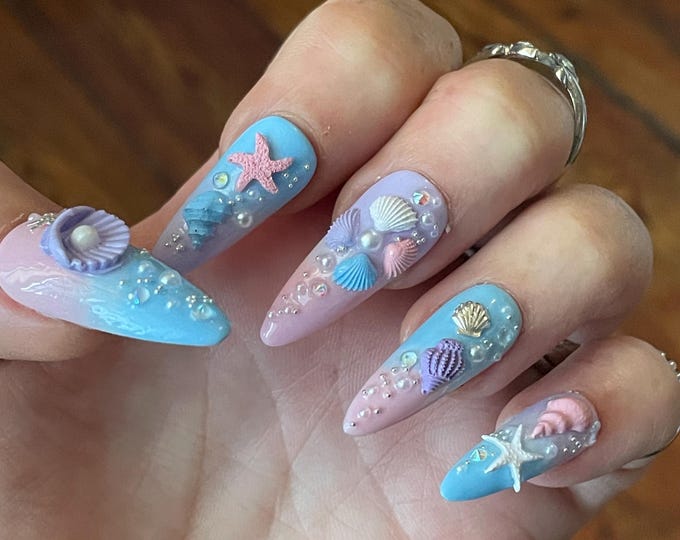 Shells, stars, fish, pearls, and rhinestones. Blue, pink, and purple. Reusable, Press-on nails, false nails. Glossy finish