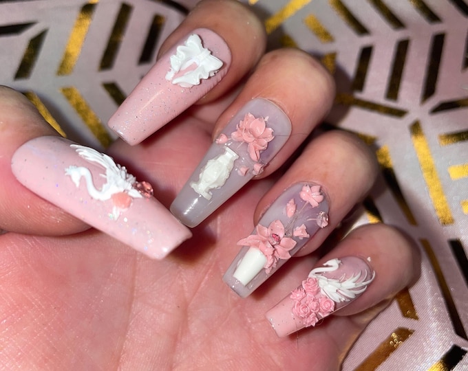 20-piece kit. Pink and milky with white signs and flowers. Sizes 0 to 9. Reusable, press-on nails, false nails. Glossy finish