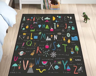 May include: Black and white alphabet rug with colourful illustrations of objects and words starting with each letter. The rug features a playful and educational design for children.