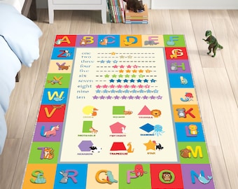 May include: A colourful alphabet play rug with a white background. The rug features the alphabet, numbers 1-10, and various geometric shapes. The rug is decorated with animal illustrations.