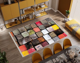 May include: Rectangular area rug with a wood block design. The rug features a pattern of square blocks in various colors, including red, yellow, green, and white, with a distressed wood grain texture. The rug is placed on a wooden floor.