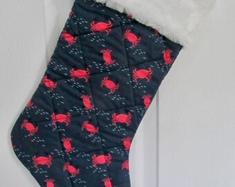Coastal crabs on navy blue Christmas stocking lined and quilted white fur top