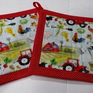 Puede incluir: Dos agarraderas de olla acolchadas rojas y blancas con un tema de granja. Las agarraderas de olla presentan una variedad de animales de granja, incluidos cerdos, vacas, pollos y tractores. Las agarraderas de olla tienen un borde rojo con lunares blancos.