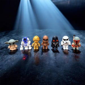 May include: A collection of Star Wars character figurines, including Baby Yoda, R2-D2, C-3PO, Chewbacca, Darth Vader, a Stormtrooper, and Boba Fett. Each figure is brightly colored and stands upright, showcasing iconic details.
