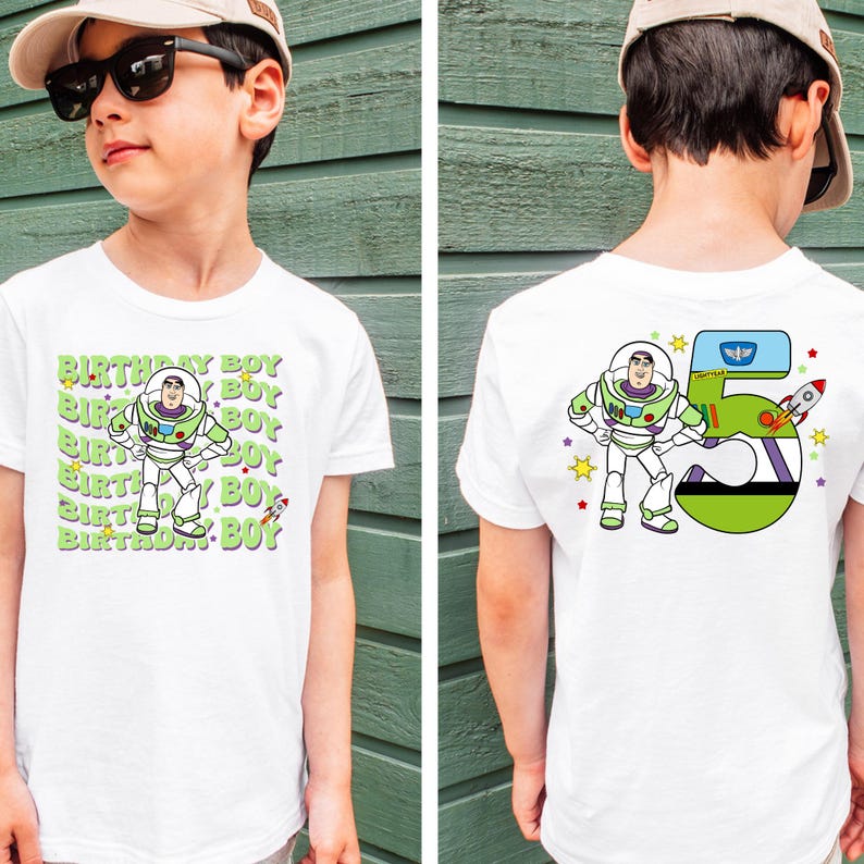 a young boy wearing a white shirt with a cartoon character on it