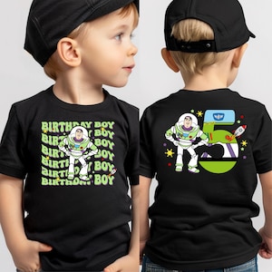 two young boys wearing matching shirts and hats