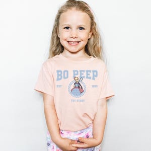 a little girl that is standing up with her hands in her pockets