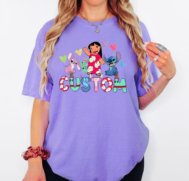 A woman wearing a purple t-shirt with a cartoon character design and the word "CUSTOM" printed on it.