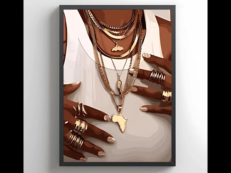 May include: A close-up of a person's hands wearing multiple gold rings and a layered gold necklace with a pendant shaped like the continent of Africa.