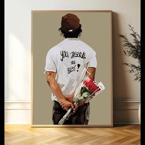 May include: A man wearing a white t-shirt with the text "You Deserve The Best!" printed on the back, holding a bouquet of red roses. He is wearing a brown baseball cap and is facing away from the camera.
