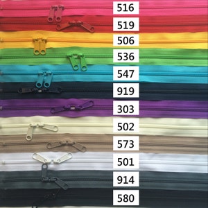 May include: A variety of zipper tapes in different colors, including pink, red, yellow, green, blue, purple, beige, white, and black. Each tape has a number printed next to it, such as 516, 519, 506, 536, 547, 919, 303, 502, 573, 501, 914, and 580.