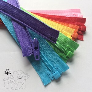 Puede incluir: Un surtido de cremalleras arco&iacute;ris en varios colores, incluyendo morado, azul, verde, amarillo, naranja, rojo y rosa. Las cremalleras est&aacute;n dispuestas en forma de abanico, con la cremallera morada en la parte superior y la cremallera rosa en la parte inferior.