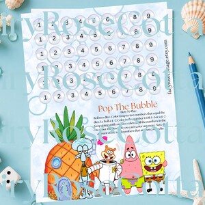 May include: A printed game sheet titled "Pop The Bubble" featuring SpongeBob SquarePants characters. The game sheet has numbered bubbles and instructions for play. Dice, a pencil, and seashells are arranged around the sheet.