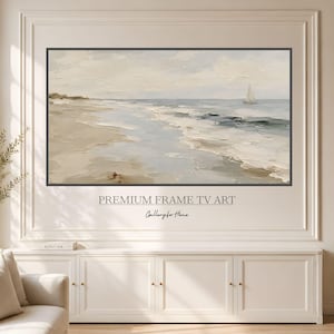 May include: A rectangular wall-mounted television displaying a landscape painting of a beach with a sailboat on the water. The artwork features neutral tones of beige, white, and soft blue. Text below the screen reads PREMIUM FRAME TV ART.