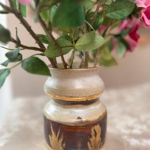 Handmade vase with earthy tones and gold details