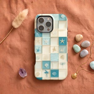 May include: A smartphone case featuring a grid pattern of square tiles in shades of white, cream, and light blue. Each tile displays a unique coastal motif, including starfish, seashells, palm trees, and ocean waves, creating a beach-themed design.