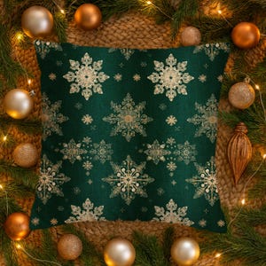 May include: A square throw pillow featuring a deep forest green fabric base with a repeating pattern of intricate, metallic gold snowflakes of varying sizes distributed evenly across the entire surface of the cushion cover.