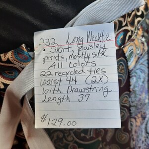 May include: A long skirt made from recycled ties with a paisley print. The skirt is 44 inches in waist and 37 inches in length. The skirt has a drawstring and is available for $129.00.