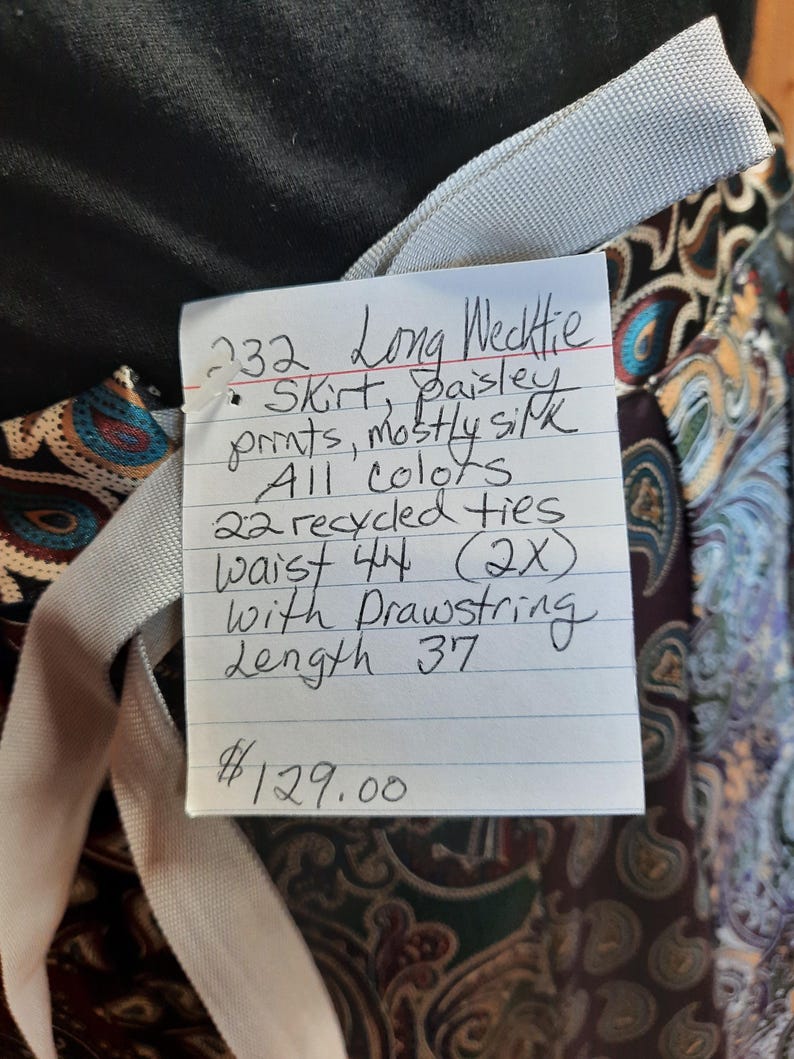 May include: A long skirt made from recycled ties with a paisley print. The skirt is 44 inches in waist and 37 inches in length. The skirt has a drawstring and is available for $129.00.