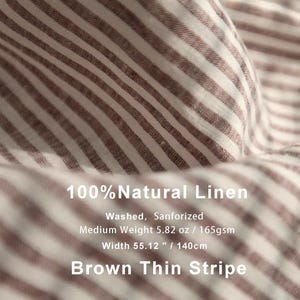 May include: Close-up of brown and white striped linen fabric. The fabric is 55.12 inches (140cm) wide and medium weight. The text on the image reads "100% Natural Linen" and "Brown Thin Stripe".