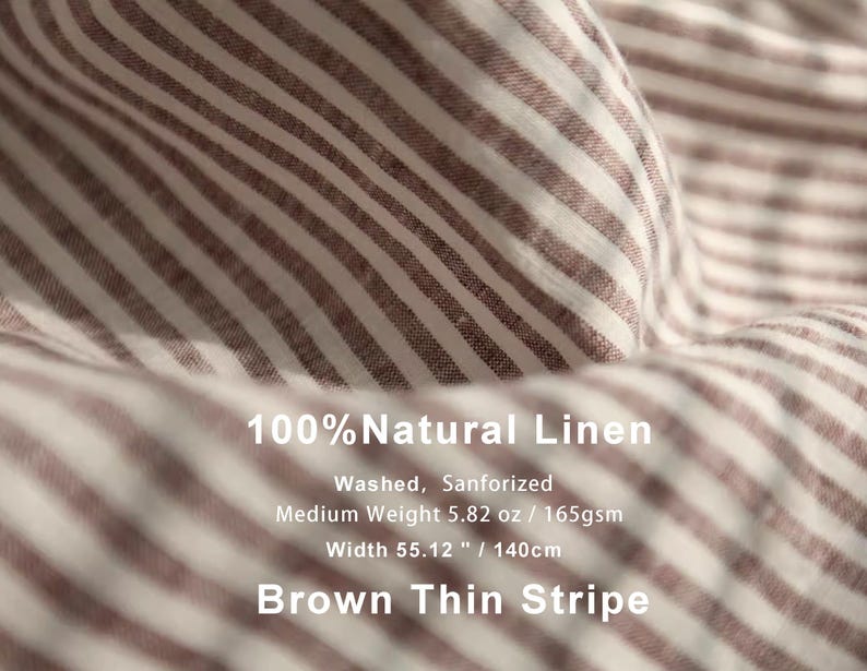 May include: Close-up of brown and white striped linen fabric. The fabric is 55.12 inches (140cm) wide and medium weight. The text on the image reads "100% Natural Linen" and "Brown Thin Stripe".